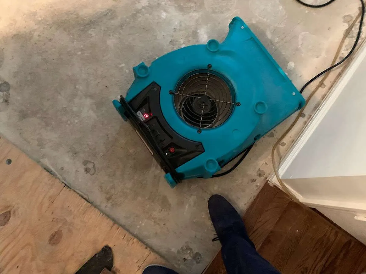 Air mover drying subfloor during Leak Detection & Repair in Glasgow